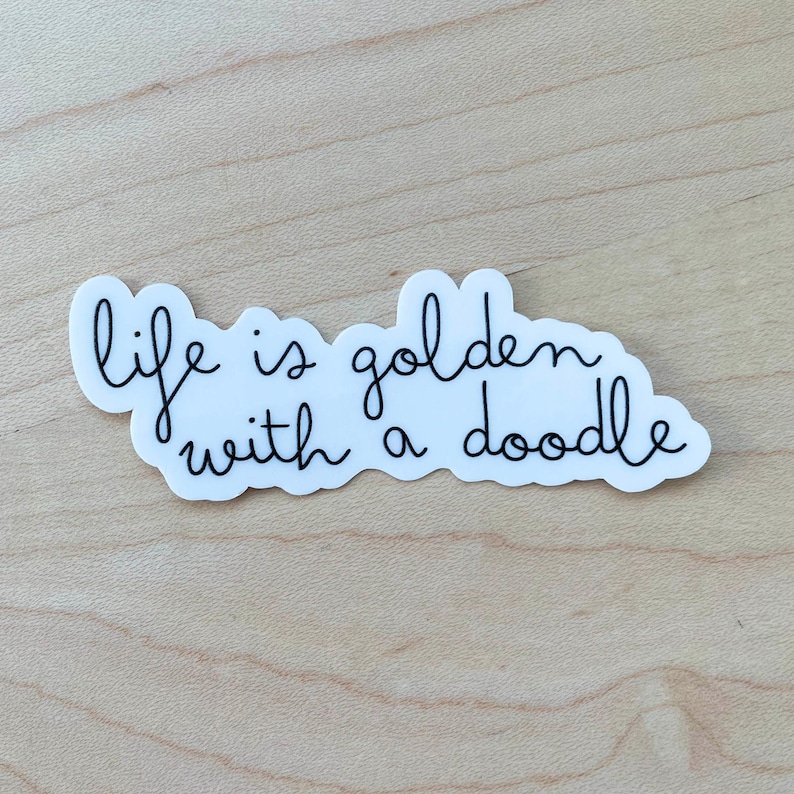 May include: White sticker with black cursive text that reads "life is golden with a doodle".