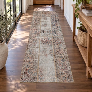 May include: A long rectangular runner rug featuring a distressed, faded pattern in shades of blue, rust orange, and cream. The design incorporates intricate floral and geometric motifs arranged in a patchwork style with a worn, vintage appearance.