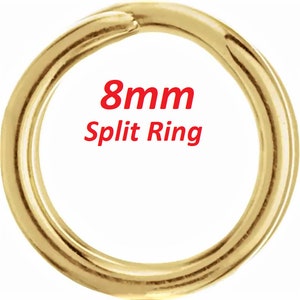 May include: A gold-colored 8mm split ring. This is a metal ring that is split open, allowing it to be attached to other items.