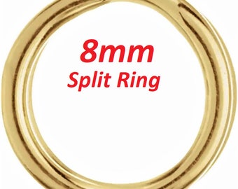 May include: A gold-colored 8mm split ring. This is a metal ring that is split open, allowing it to be attached to other items.