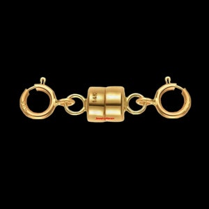 May include: Gold magnetic clasp for a necklace or bracelet. The clasp is marked "14K" and has two round loops on either side.
