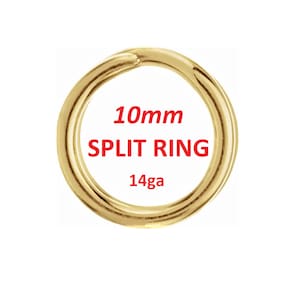 May include: A gold-coloured split ring, 10mm in diameter, with a 14-gauge thickness. The text "SPLIT RING" is displayed in red, with the size and gauge information. The ring is circular and has a bright, metallic finish.