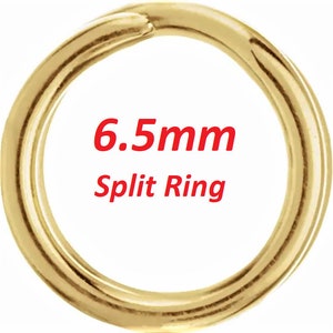 May include: A gold-colored 6.5mm split ring. This is a metal ring that is often used for attaching jewelry or other items.