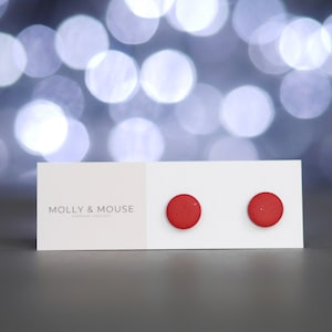 May include: A pair of red stud earrings on a white card with the text "MOLLY & MOUSE HANDMADE JEWELLERY".