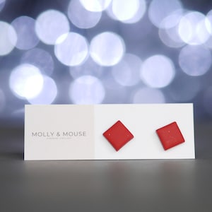 May include: A pair of red square stud earrings on a white card with the text "MOLLY & MOUSE HANDMADE JEWELLERY".