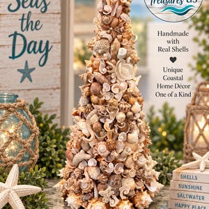 May include: A conical decorative tree sculpture constructed from a variety of natural seashells in shades of tan, beige, cream, and white. The structure is densely covered in assorted spiral, bivalve, and coral-like shells, topped with a single white shell.