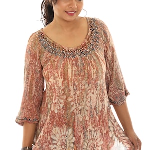 May include: A brown and beige patterned tunic top with a beaded neckline and lace trim. The top has a loose fit and 3/4 sleeves.