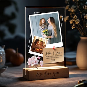 May include: A personalized photo lamp with a wooden base. The lamp features two printed photos and a note that reads "Julia & Grace, From the start, best friends forever from the heart 2026." The base says "We love you..."