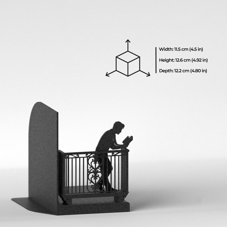 Puede incluir: Un sujetalibros de metal negro con la silueta de una persona leyendo en un balc&oacute;n. Las dimensiones del producto son 11,5 cm de ancho, 12,6 cm de alto y 12,2 cm de profundidad, junto a un icono de cubo 3D con flechas direccionales.