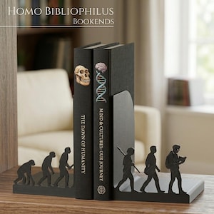 May include: A pair of black metal bookends featuring a silhouette of human evolution. The left piece shows the progression from a primate to a standing human, while the right piece depicts a modern human carrying a backpack and reading a book.