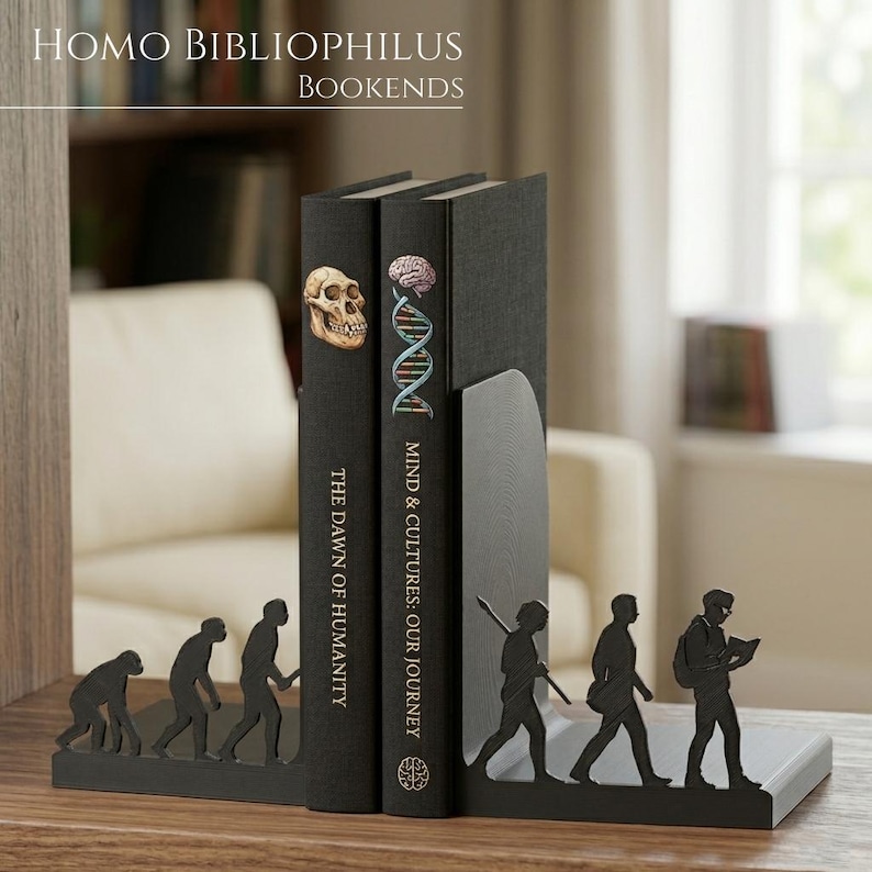 May include: A pair of black metal bookends featuring a silhouette of human evolution. The left piece shows the progression from a primate to a standing human, while the right piece depicts a modern human carrying a backpack and reading a book.