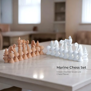 May include: A marine-themed chess set with ocean-inspired sculptural chess pieces. The chess pieces are arranged on a marble-like surface. One side is peach-colored, and the other is white. The text "Marine Chess Set" and "Ocean-Inspired Sculptural Chess Pieces" is visible.
