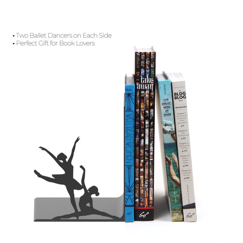 May include: A gray metal bookend featuring a silhouette of two ballet dancers. The bookend is holding several books with titles including "Take Away", "Well Read Women", and "The Greatness of Dads".