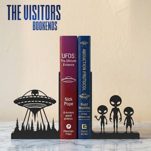 May include: Black metal bookends with a UFO and alien design. The bookends hold two books titled "UFOS: The Ultimate Evidence" and "Abduction Protocol". The text "The Visitors Bookends" is at the top.