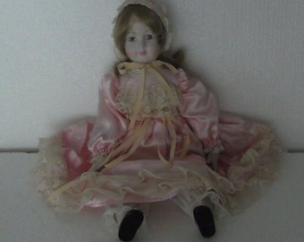 Vintage Doll Porcelain doll, painted eyes pink dress 40cm.
