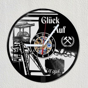 May include: Black vinyl record clock featuring a design of a mine shaft, a coal cart, and the text "Glück Auf" with a crossed pickaxe and laurel wreath.