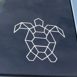 以下が含まれることがあります： 濃い青色の背景に白い幾何学的な亀のステッカー
