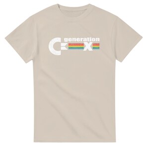 May include: A beige t-shirt with the text "generation X" in white and a rainbow-colored stripe design. The letter "C" is on the left side of the text, and the letter "X" is on the right side.