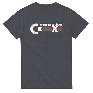 May include: Dark gray t-shirt with the text "generation X" in a distressed white font. The "X" is a rainbow of colors. The shirt is a short-sleeved crew neck.