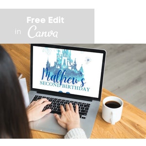 May include: A laptop screen displaying a blue and white watercolor illustration of a castle with the text "Mathew's Second Birthday" on a white background. The laptop is on a wooden table with a cup of coffee.
