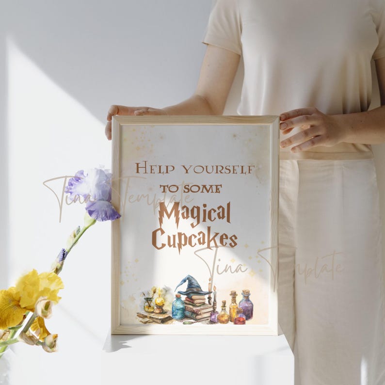 May include: A sign with the text "Help yourself to some Magical Cupcakes" in copper lettering. The sign is decorated with a watercolor illustration of a wizard's hat, books, and potion bottles.