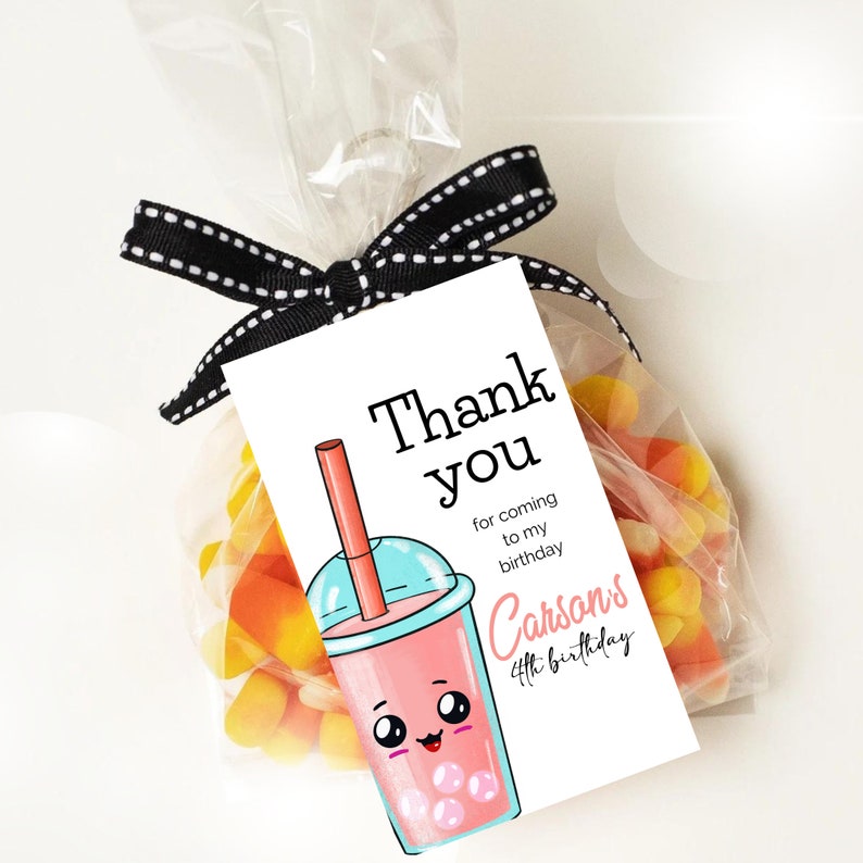 May include: A white thank you tag with a cartoon illustration of a pink bubble tea with a blue lid and a red straw. The text on the tag reads "Thank you for coming to my birthday Carson's 4th birthday".
