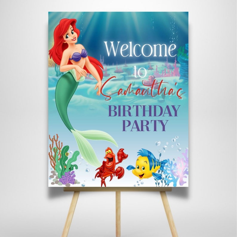 May include: A welcome sign for a birthday party featuring Ariel, the Little Mermaid, with Sebastian and Flounder. The sign is blue and green with white text that reads "Welcome to Samantha's Birthday Party".