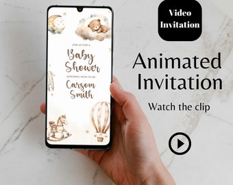 May include: A smartphone displaying a baby shower invitation with a watercolor design featuring a teddy bear, a hot air balloon, a rocking horse, and stars. The text on the invitation reads "Join us for a Baby Shower Honoring Mom-to-be Carsom Smith".