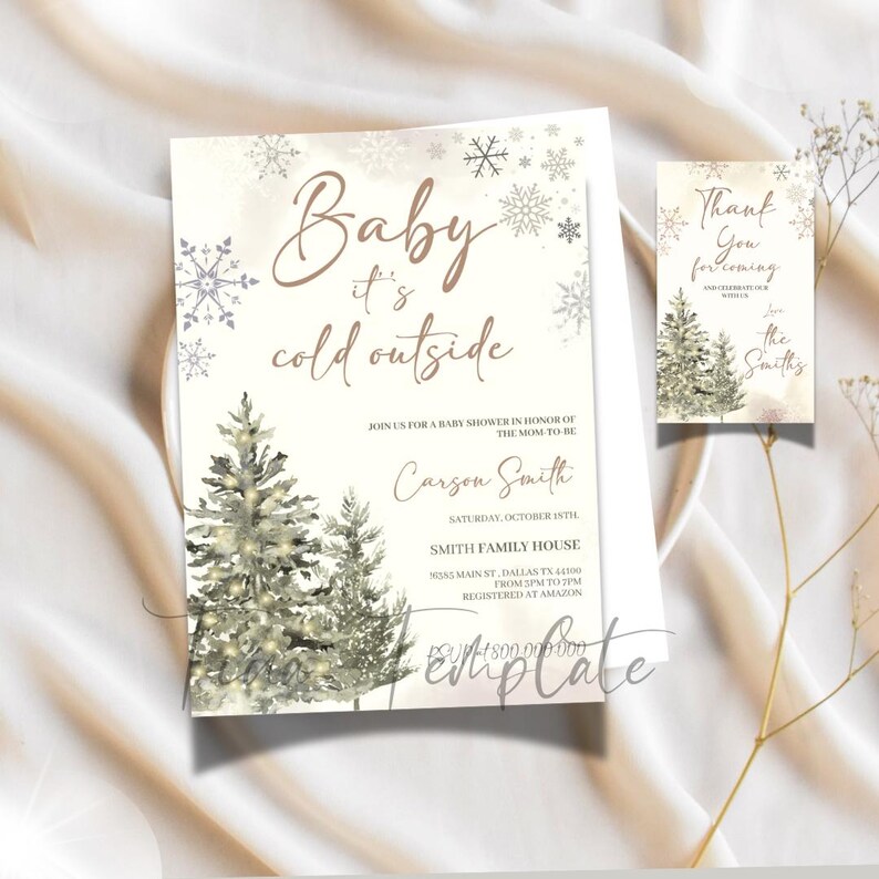 May include: Winter-themed baby shower invitation with a watercolor illustration of two pine trees with lights. The invitation reads "Baby it's cold outside" and includes the name "Carson Smith" and details for the event. A thank you card with a similar design reads "Thank you for coming" and is signed "Love the Smiths".