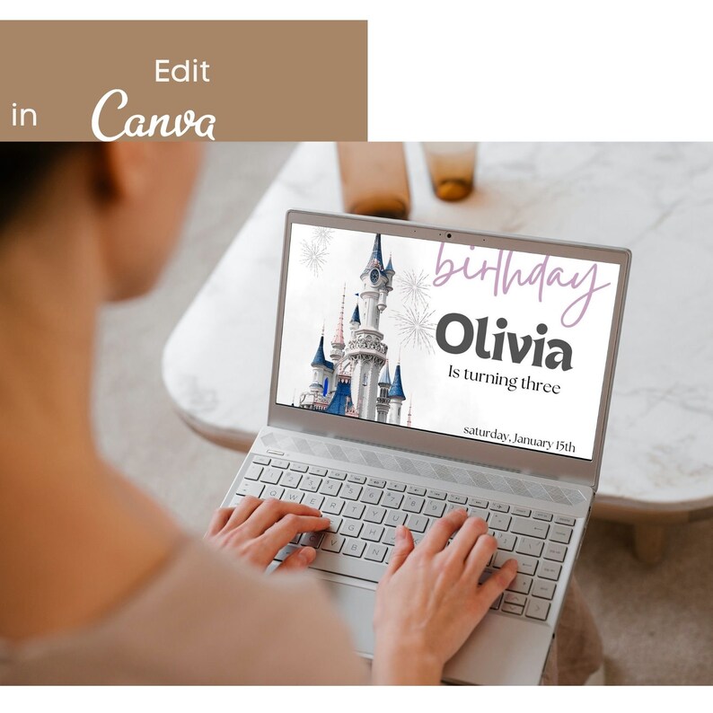 May include: A laptop screen displaying a birthday invitation with a picture of Cinderella's castle from Disney World. The invitation reads "birthday Olivia is turning three saturday, January 15th".