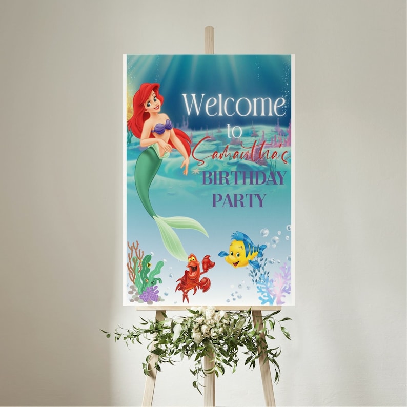 May include: Welcome to Samantha's Birthday Party sign featuring Ariel the Little Mermaid, Flounder, and Sebastian. The sign has a blue background with bubbles and coral.