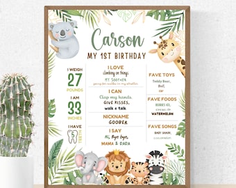 May include: A green and gold jungle-themed first birthday milestone poster for a boy named Carson. The poster features a koala, giraffe, elephant, lion, tiger, and zebra. It includes details about Carson's age, weight, height, favorite toys, foods, and songs.