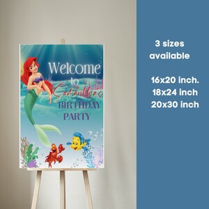 May include: Welcome to Samoutha's Birthday Party sign featuring Ariel the Little Mermaid, Flounder, and Sebastian. The sign is printed on a blue background with bubbles and seaweed. Available in 16x20 inch, 18x24 inch, and 20x30 inch sizes.