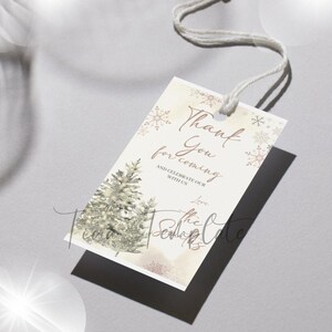 May include: A white thank you tag with a winter theme. It features a watercolor illustration of pine trees and snowflakes. The text reads "Thank You for coming and celebrate our with us. Love, the Sedlarks".