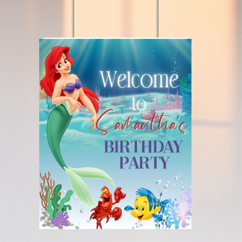 May include: A welcome sign for a birthday party featuring Ariel, the Little Mermaid, with Sebastian and Flounder. The sign is blue with white text that says "Welcome to Samantha's Birthday Party".