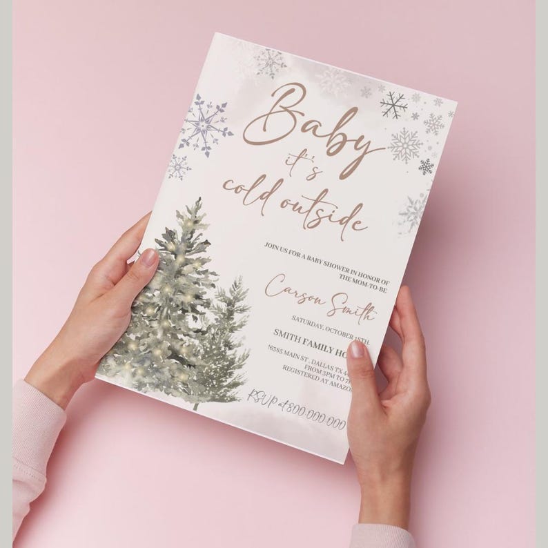 May include: A baby shower invitation with a winter theme. The invitation features a watercolor illustration of two pine trees with white snow and lights. The text reads "Baby it's cold outside" with the name "Carson Smith" and details for the shower.