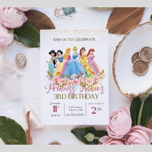 May include: A white invitation with gold glitter and pink flowers. It says "Join us to celebrate Princess Annie's 3rd Birthday". The invitation features a picture of Disney princesses, including Cinderella, Ariel, Belle, Jasmine, and Snow White. The invitation includes the date, time, and location of the party.