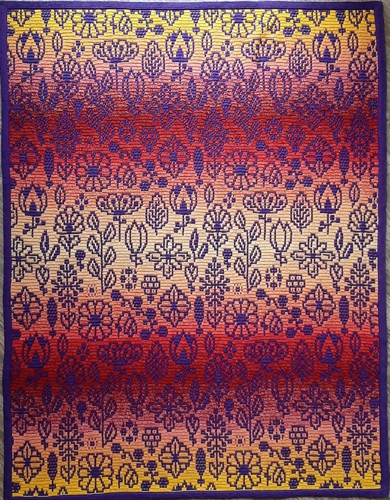 May include: A colorful woven tapestry with a gradient of red, orange, and yellow. The tapestry features a repeating pattern of stylized flowers and leaves in shades of purple, white, and black.