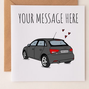 May include: A white card with a grey car illustration and the text "YOUR MESSAGE HERE".  There are red hearts above the car.