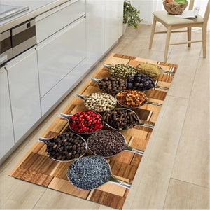 May include: A kitchen rug with a woodgrain pattern features a row of silver spoons filled with various spices, including black peppercorns, red pepper flakes, and poppy seeds.