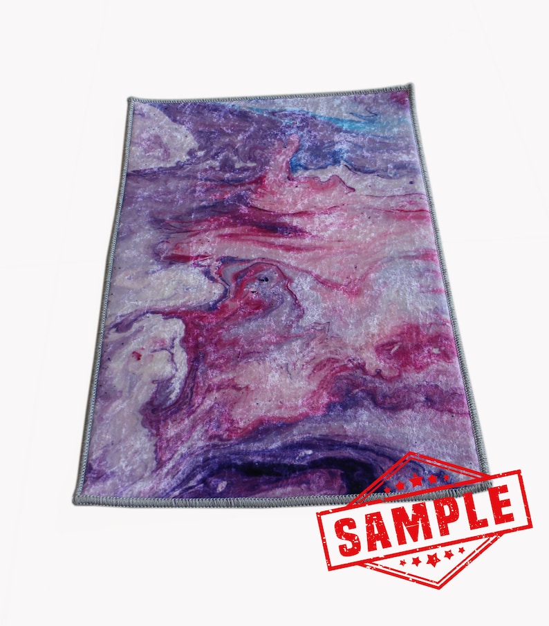 May include: Purple, pink, and white abstract marbled area rug with a gray border. The rug has a modern, contemporary design.