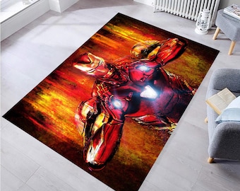 May include: A red and yellow rug with a superhero character in a red and gold suit. The character is standing in a dynamic pose with a fiery background.