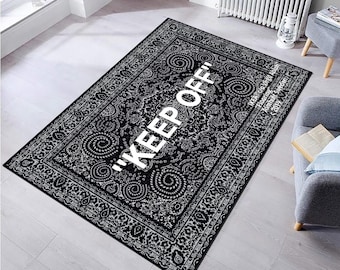 May include: Black and white patterned rug with a white "KEEP OFF!" text in the center. The rug has a traditional paisley design.