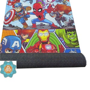 May include: A colorful rug featuring a group of superheroes, including Iron Man, Spider-Man, Captain America, Hulk, and Thor. The rug has a blue background with a comic book style design.