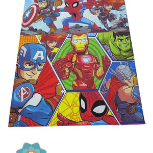 May include: A colorful rug featuring various Marvel superhero characters, including Captain America, Iron Man, Spider-Man, Hulk, and Thor. The rug has a blue background with a comic book style design.