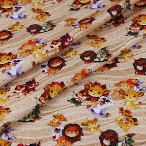 May include: Tan fabric with a repeating pattern of cartoon lions in various poses and colors. The lions have orange, brown, and yellow manes, with some wearing accessories. The background has a striped design.
