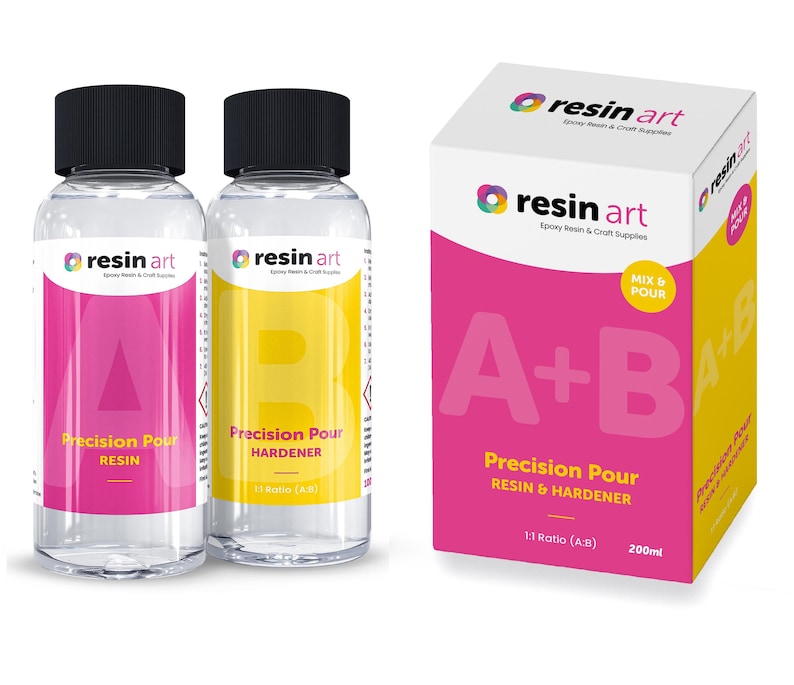 May include: Two clear bottles of resin art epoxy resin and hardener, labeled "Precision Pour Resin" and "Precision Pour Hardener". The bottles are 1:1 ratio and are packaged in a pink box with the text "resin art" and "A+B Precision Pour Resin & Hardener 1:1 Ratio (A+B) 200ml".