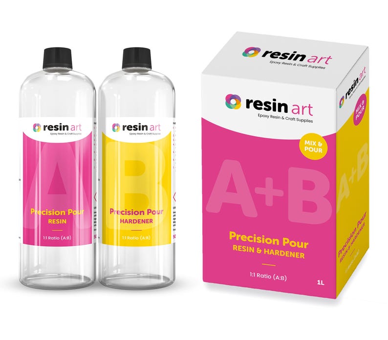 May include: Two clear bottles of resin art epoxy resin and hardener, labeled "Precision Pour Resin" and "Precision Pour Hardener". The bottles are 1:1 ratio and are next to a pink and yellow box labeled "resin art" with the text "A+B Precision Pour Resin & Hardener 1:1 Ratio (A:B) 1L"