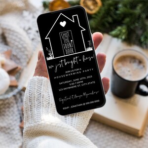 May include: Black and white housewarming party invitation on a smartphone. The invitation features a house icon with the text "Shut the front door" and the words "We just bought a house!" The invitation includes the date, time, and address of the party.