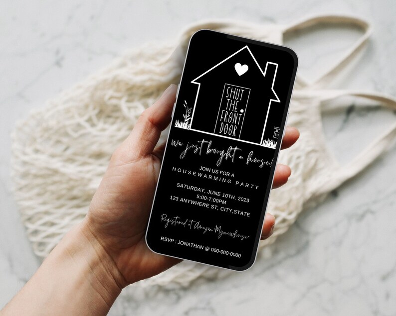 May include: Black and white housewarming party invitation on a smartphone screen. The invitation features a house icon with the text "Shut the front door" and the words "We just bought a house!"  Join us for a housewarming party on Saturday, June 10th, 2023 from 5:00-7:00 PM at 123 Anywhere St, City, State. RSVP: Jonathan 000-000-0000.